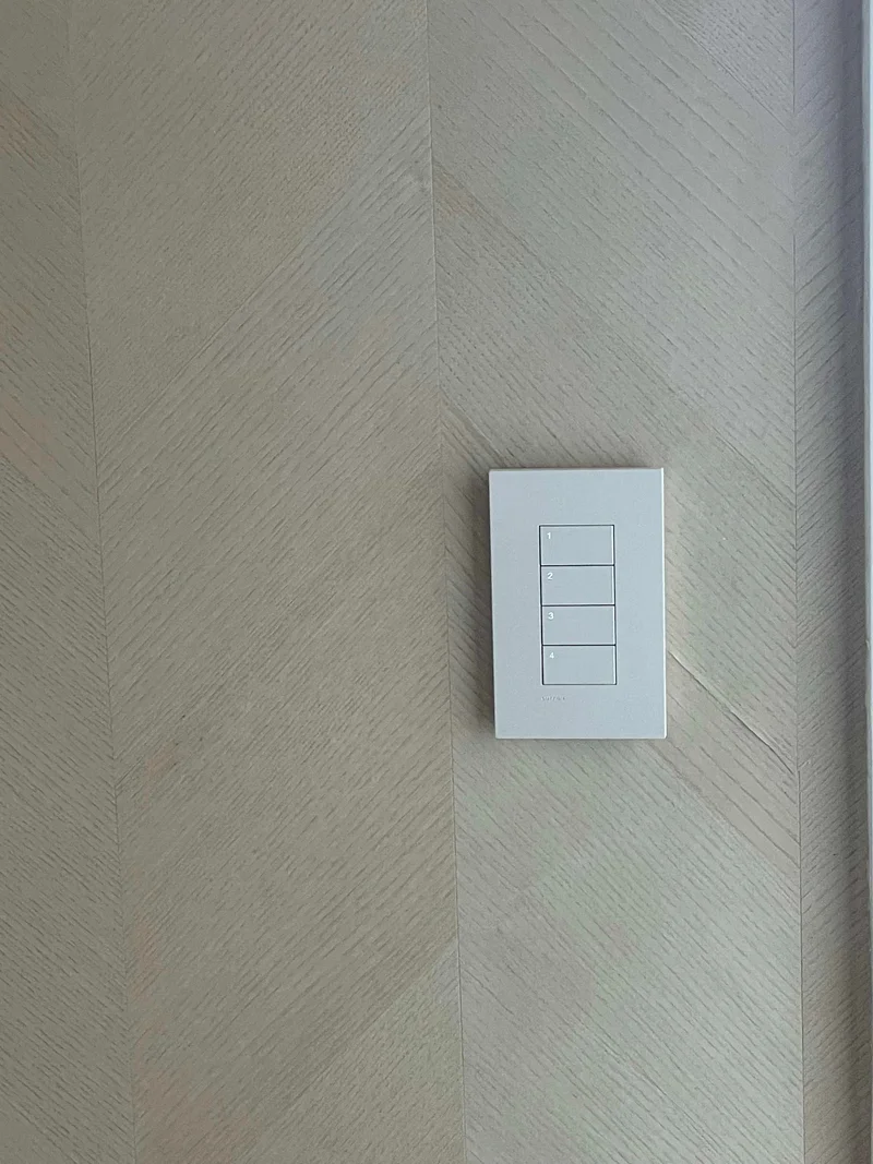 Four-button wall keypad on a finished textured wall