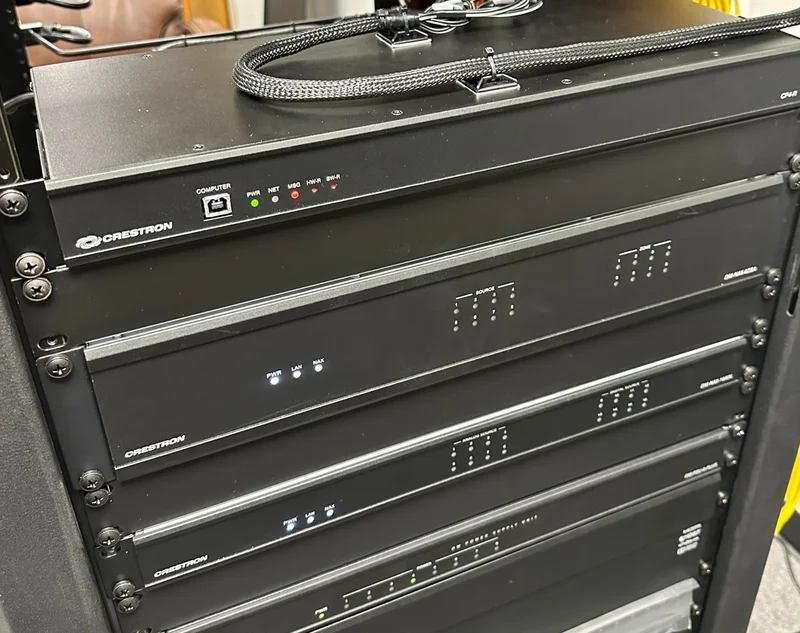 Crestron CP4-R processor and DM NAX audio components in the equipment rack