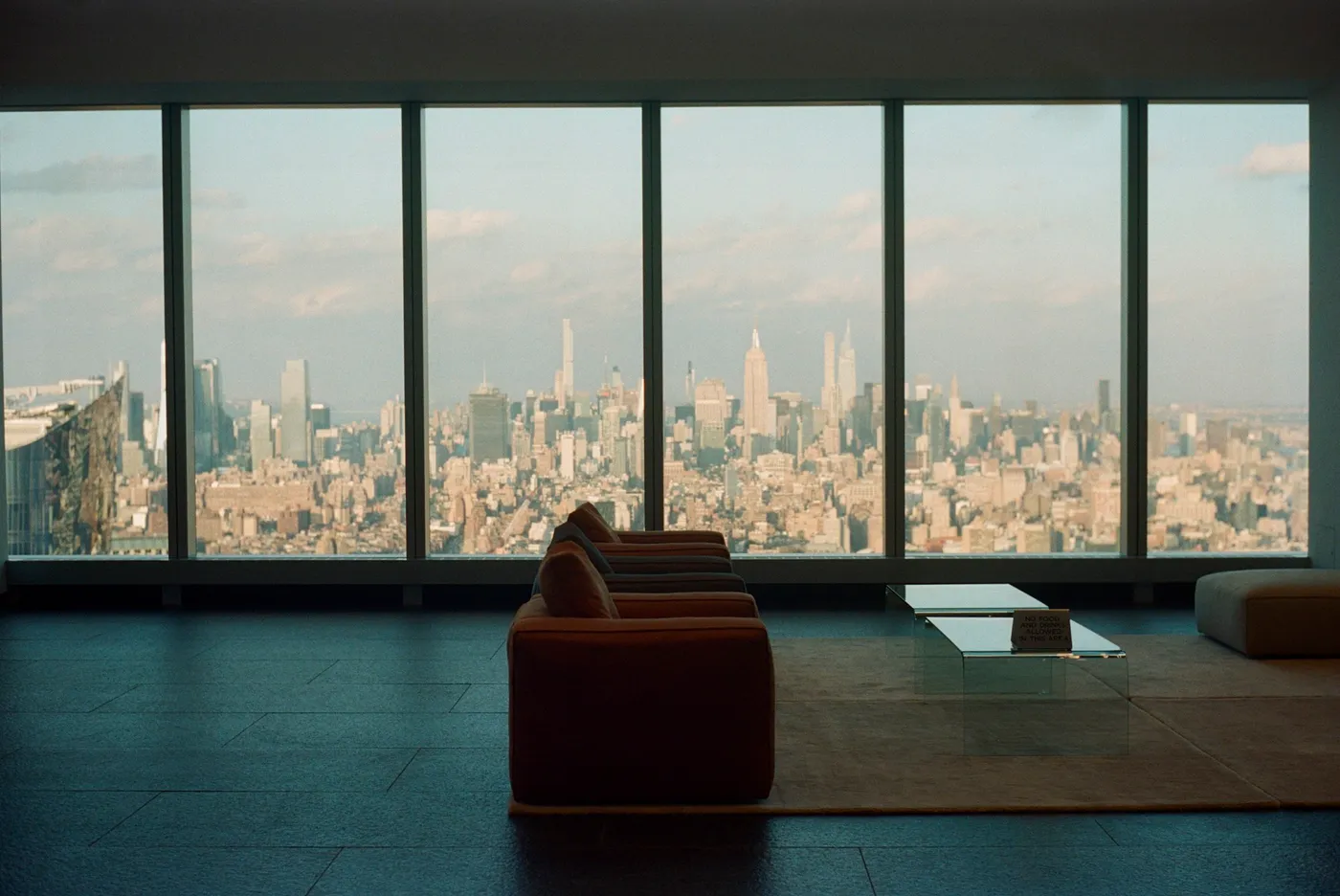 High-floor Manhattan residence living room with floor-to-ceiling windows over the skyline