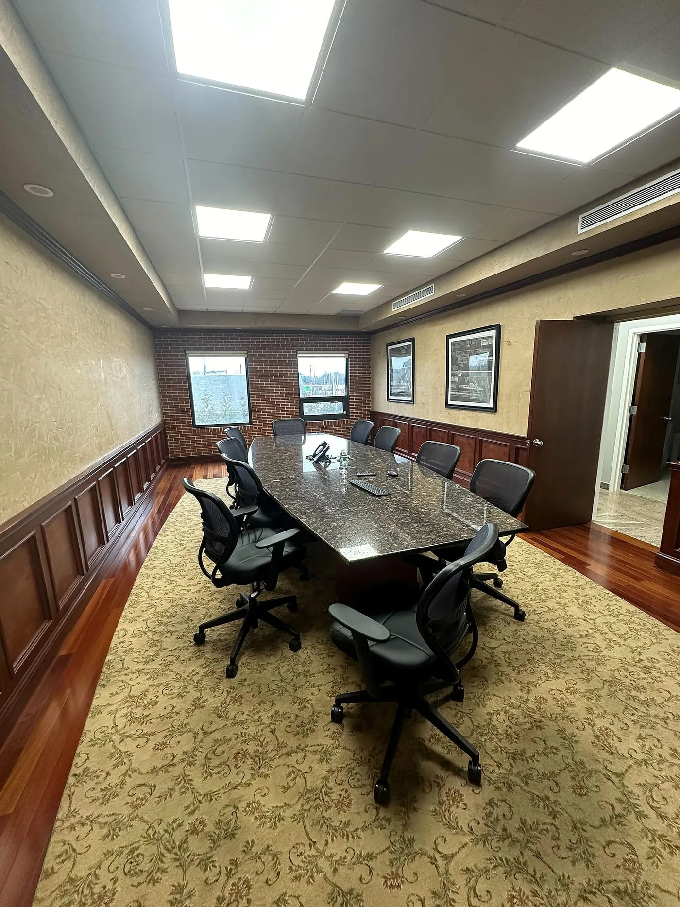 Conference room with a long table and integrated display