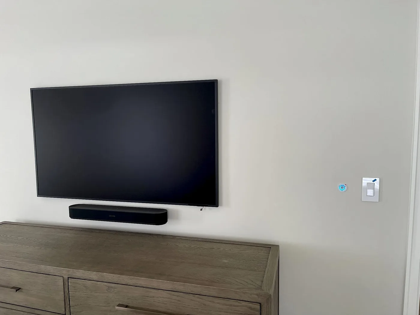 Bedroom with a wall-mounted display in a South Florida home