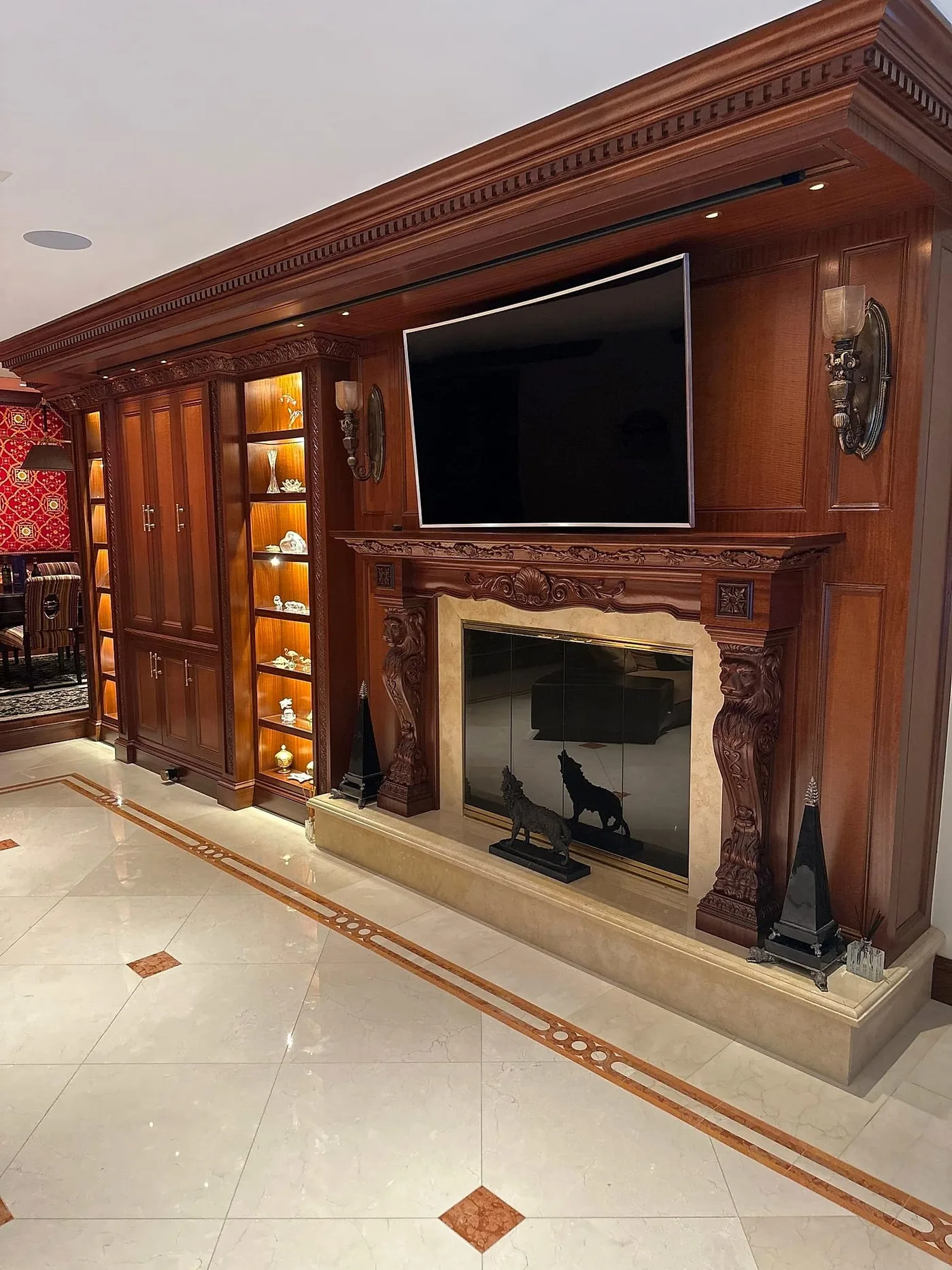 Display above a fireplace in a wood-paneled media wall