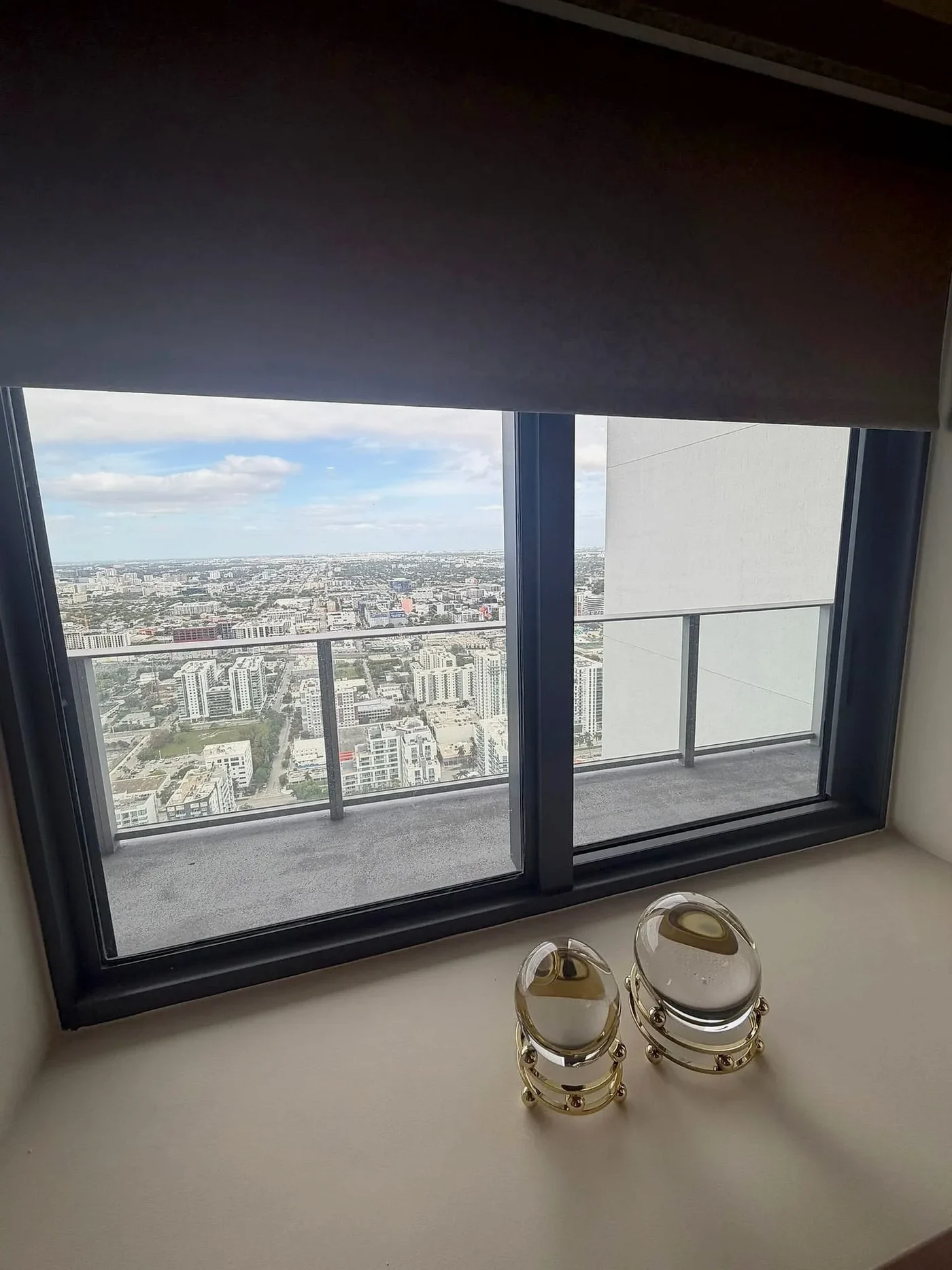 Roller shade above a city-view window