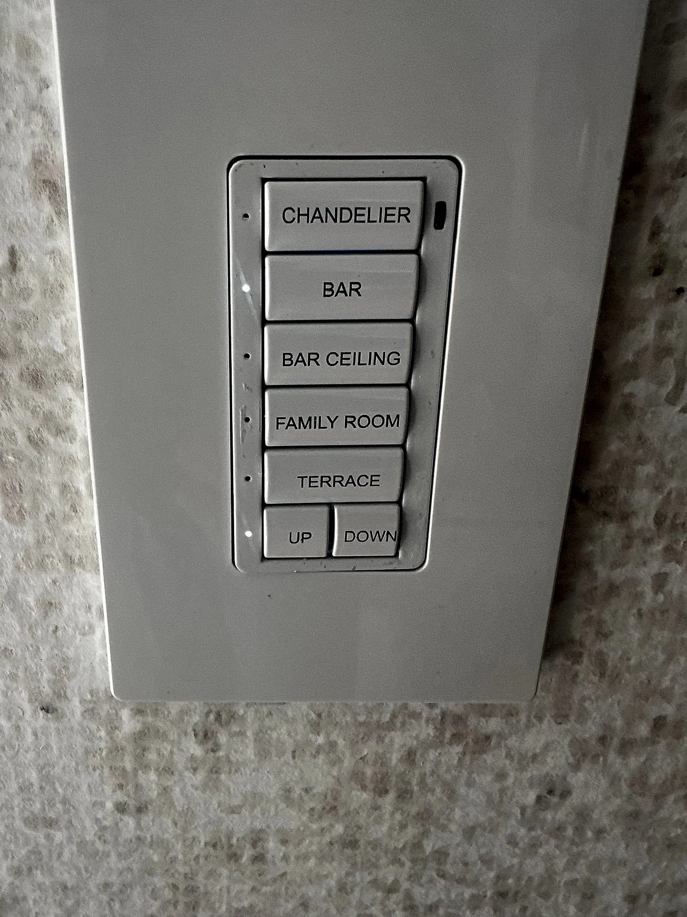 Engraved lighting keypad on a stone wall