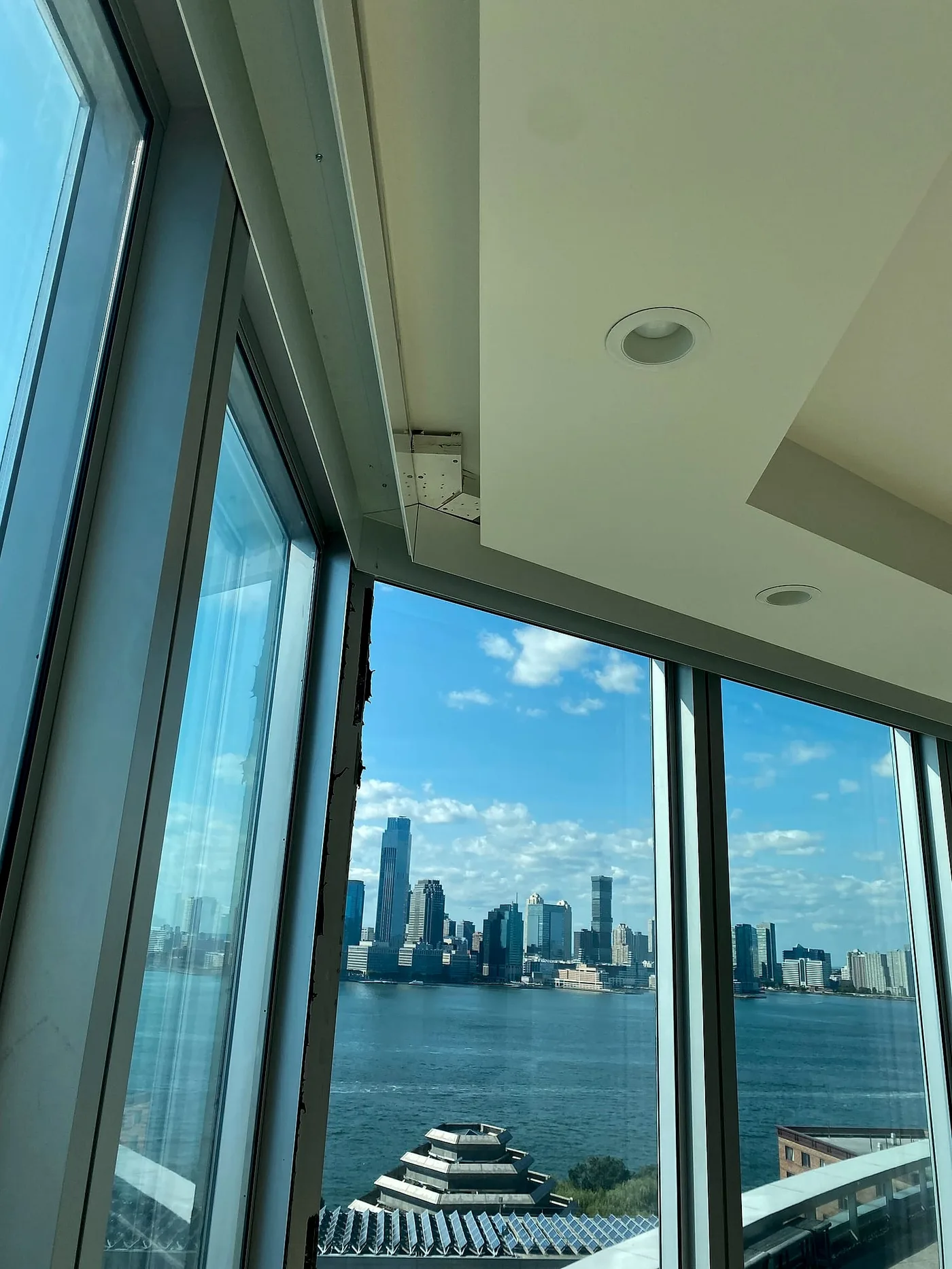 Motorized shades framing the Manhattan skyline