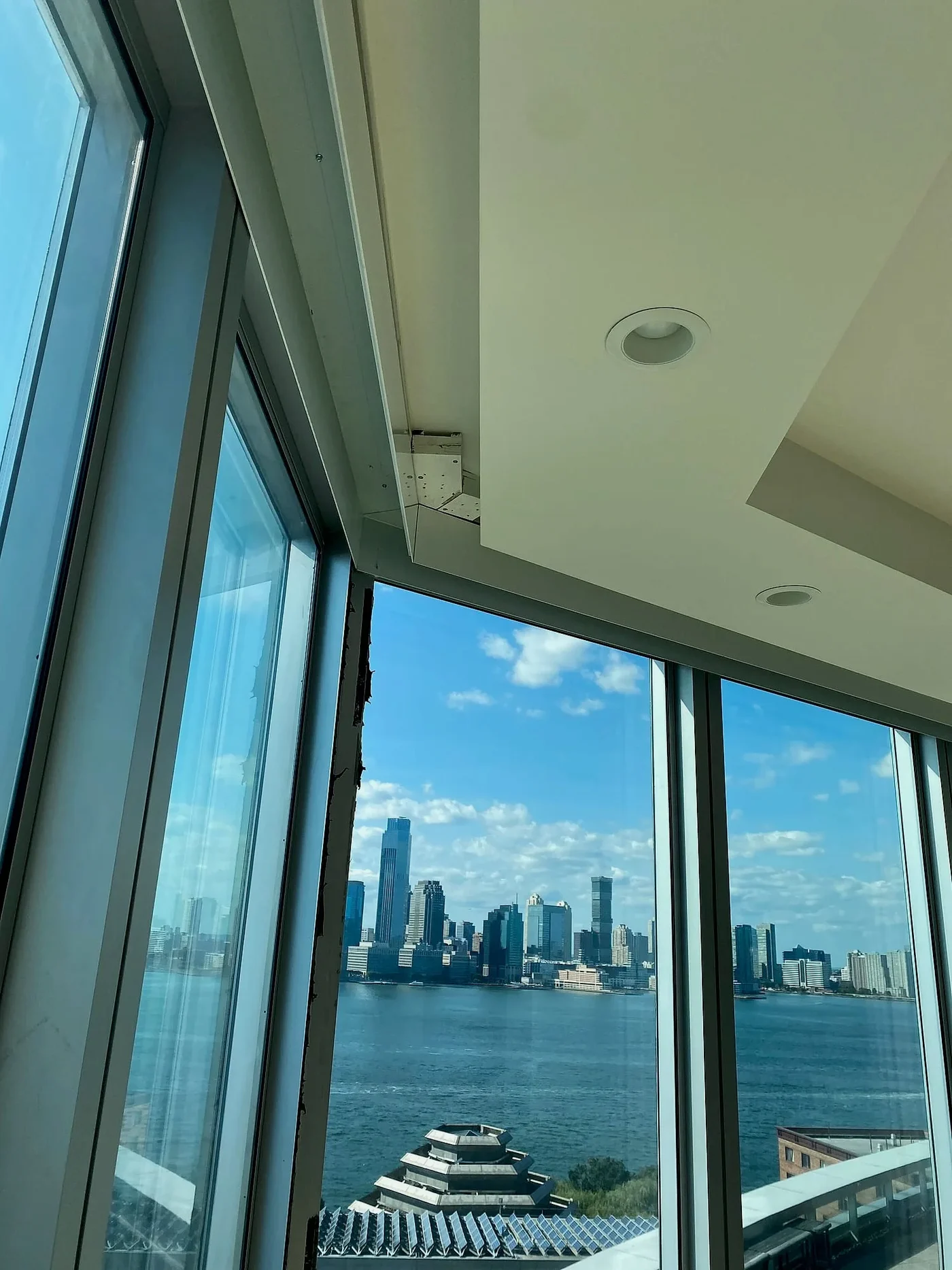 Motorized shades framing the Manhattan skyline