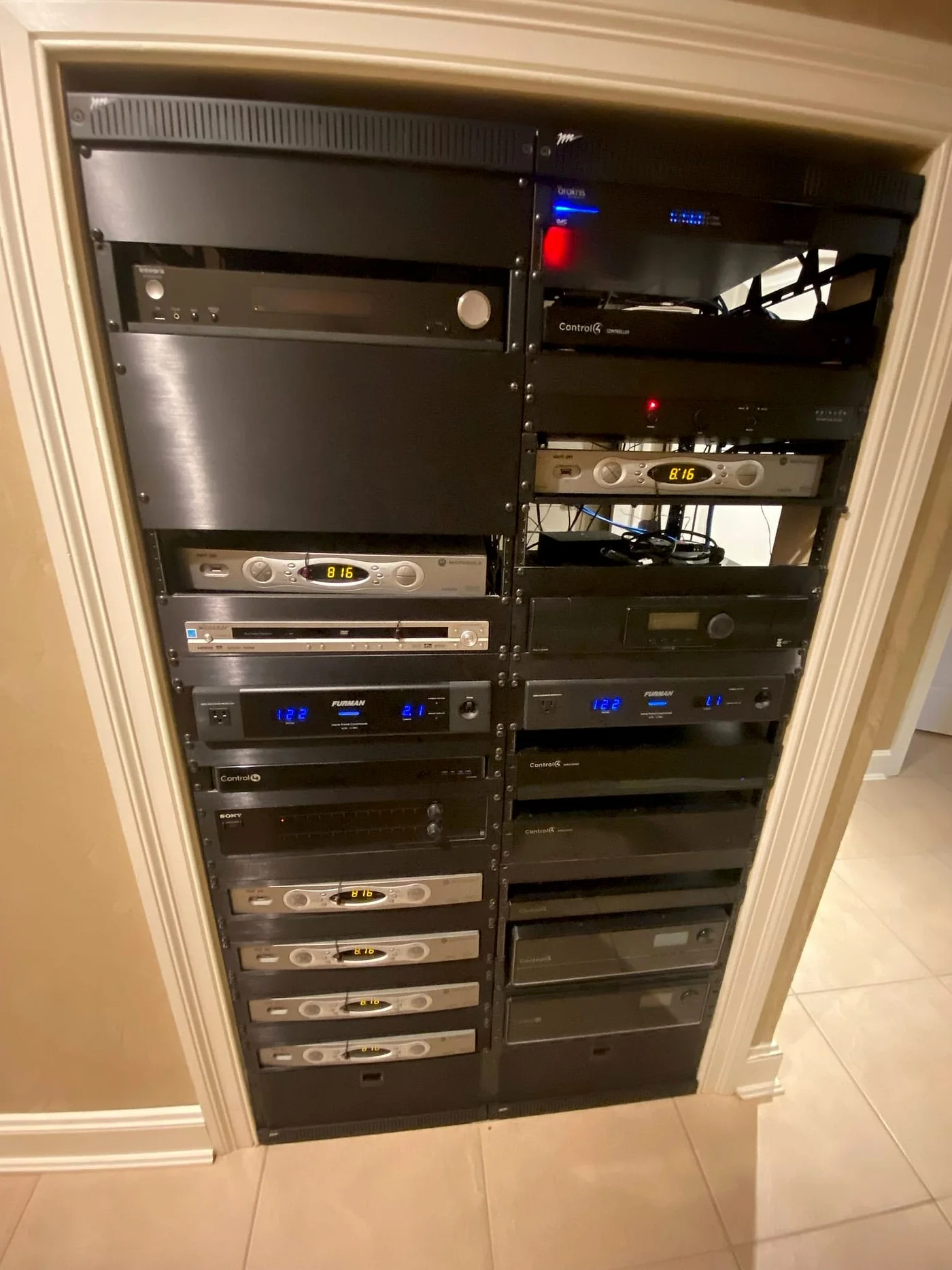 Equipment rack recessed into a wall niche
