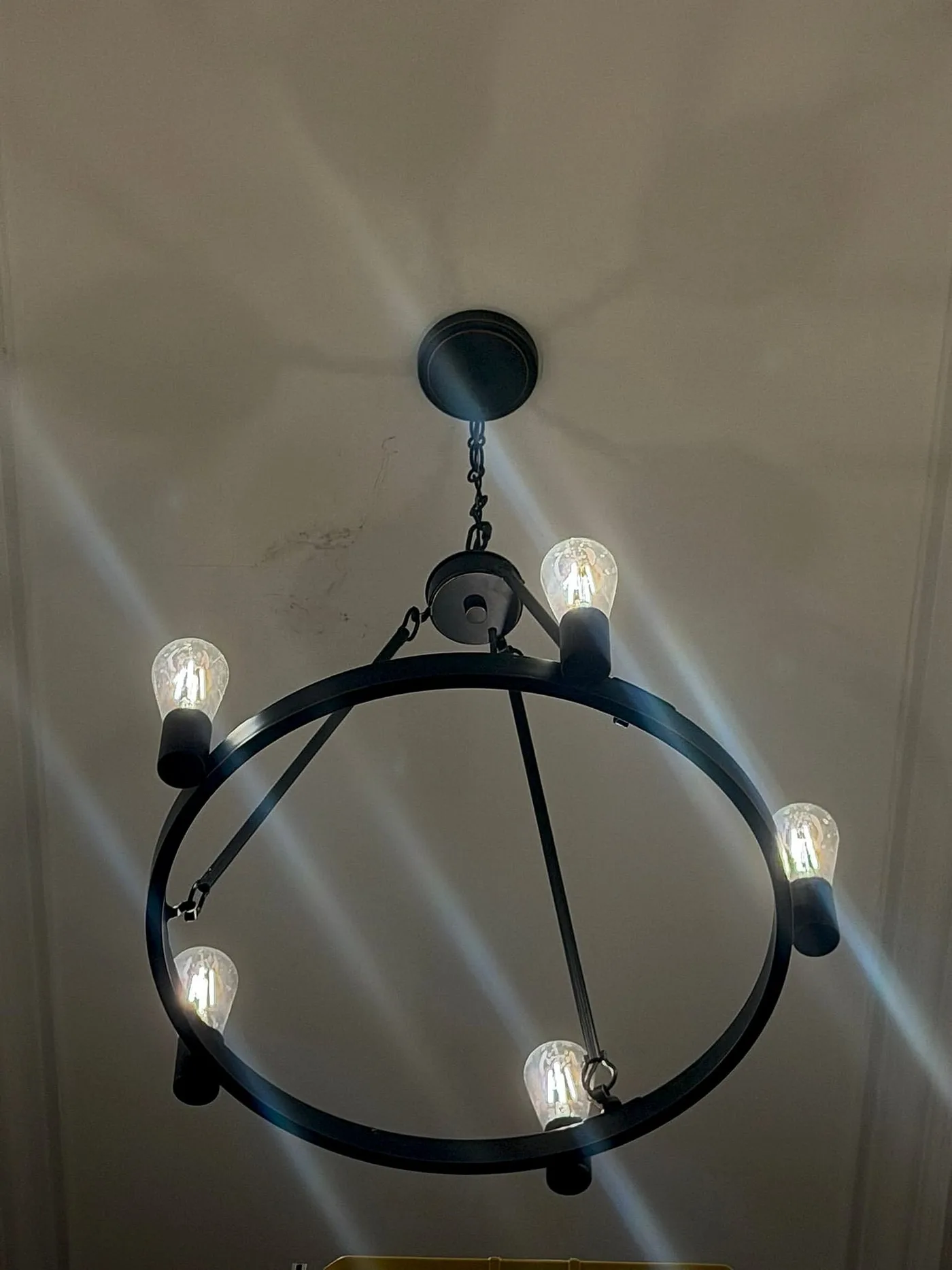 Chandelier beneath a detailed ceiling