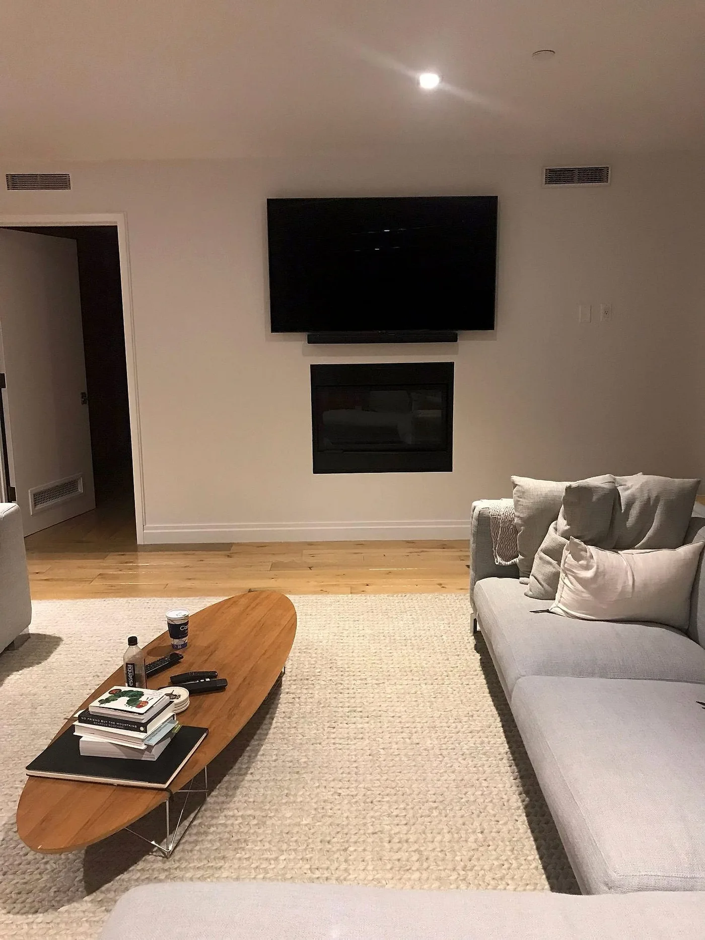 Blank wall-mounted television above a fireplace