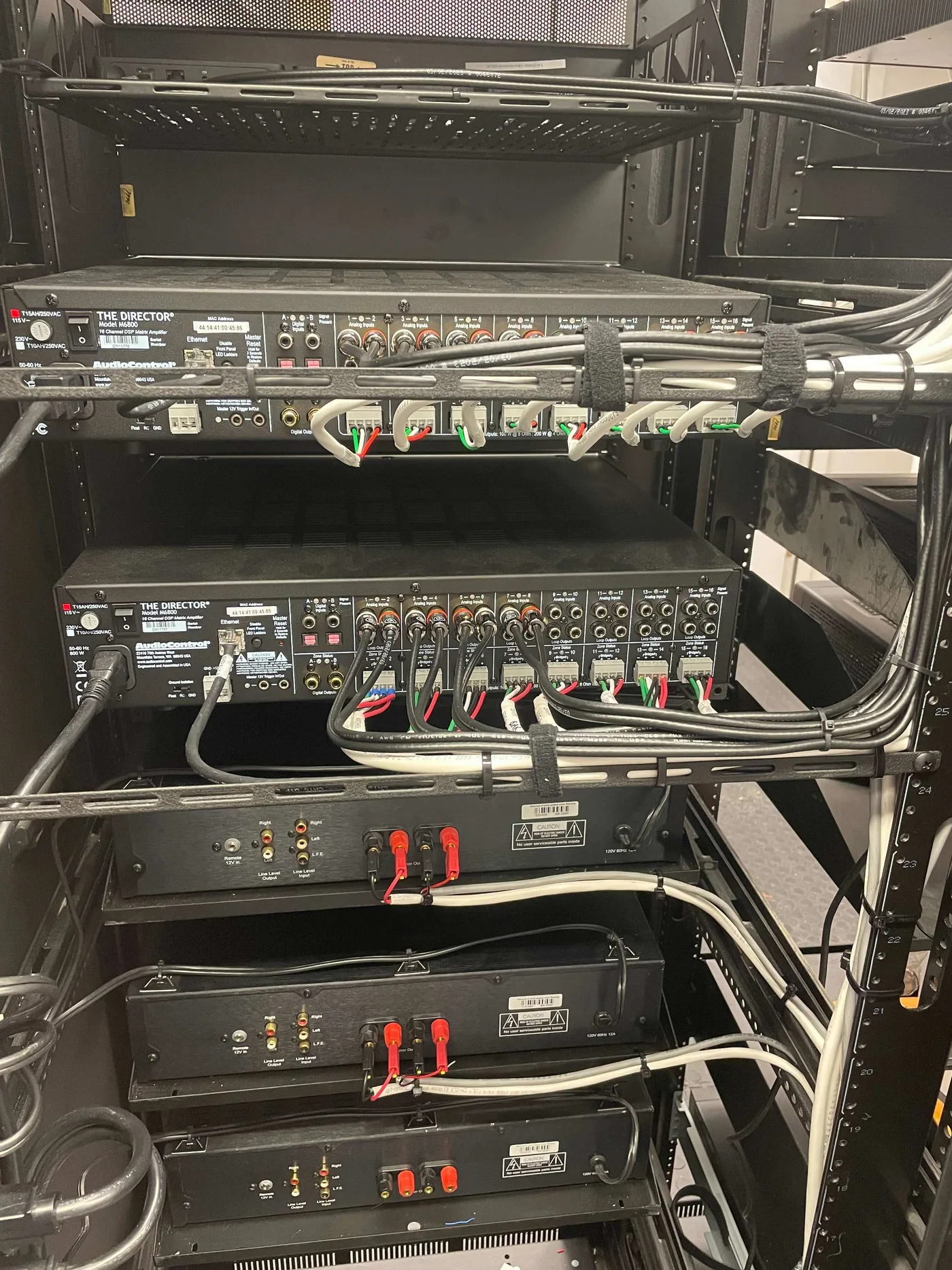 Amplifier connections supported and dressed along rear rack lacing bars