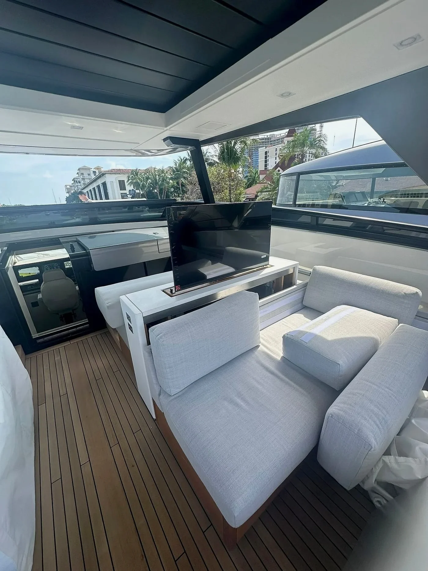 Raised television lift beside flybridge seating