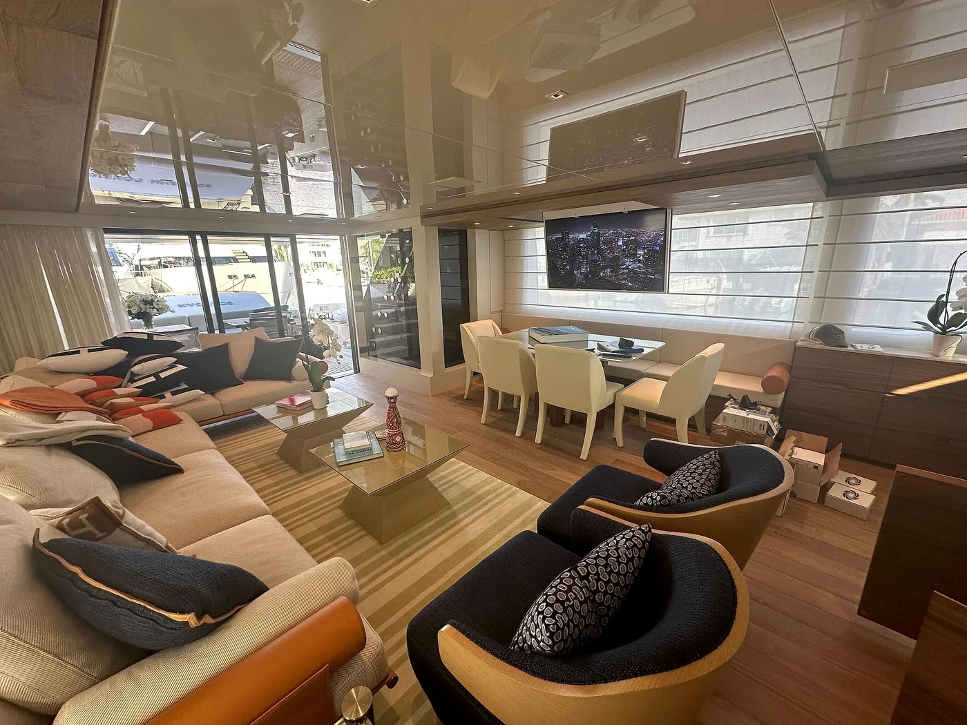 Salon seating, dining area and integrated television aboard a yacht